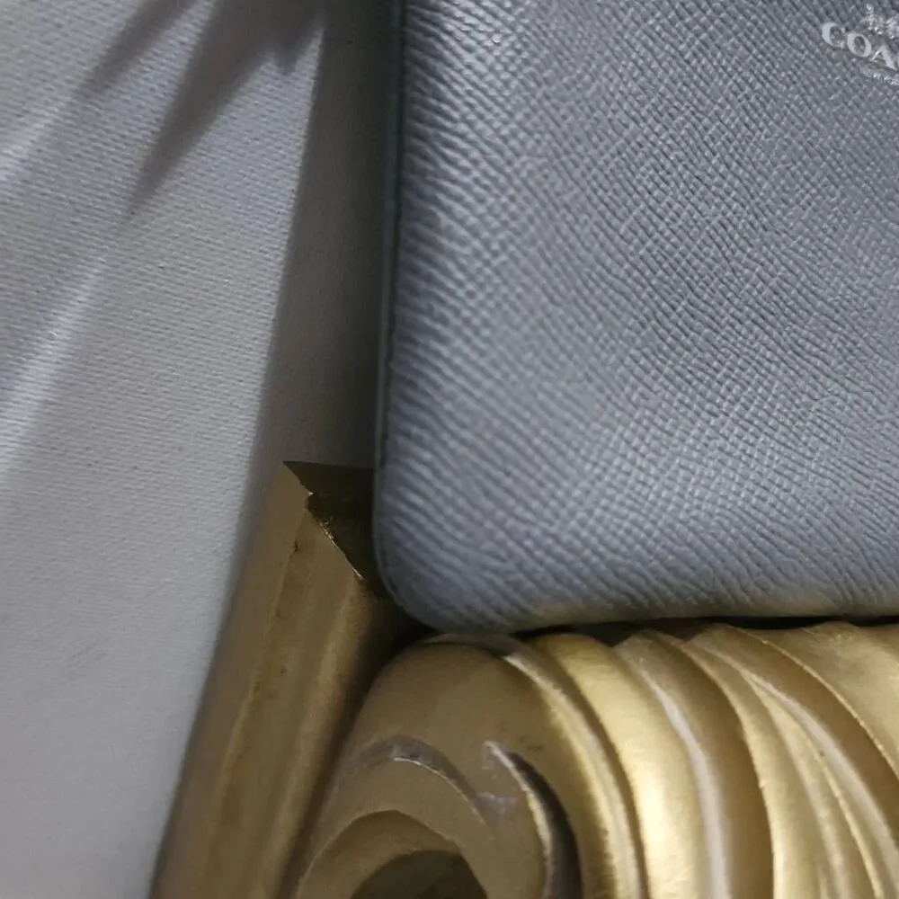 Coach Corner Zip Wristlet in a grey crossgrain leather.